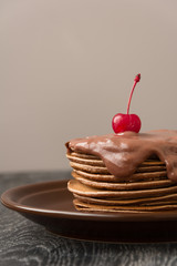 Stack of chocolate pancakes with chocolate sauce