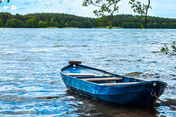 Naklejka na ściany i meble Landscape with boat on the lake shore