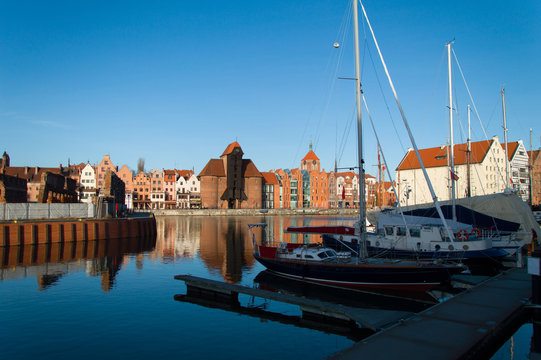 Marina for yachts at Motława River with a view of the old town of Gdansk.