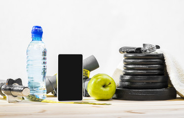 Sport Equipment. Dumbbells, Free Weights, Barbell, Hand Grip, Towel, Tape Measure, Bottle Of Water, Smart Phone To Workout Or Diet Plan On Table. Sport Fitness Background