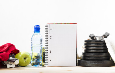 Sport Equipment. Dumbbells, Free Weights, Barbell, Hand Grip, Towel, Tape Measure, Bottle Of Water And Notepad To Workout Or Diet Plan On Table. Sport Fitness Background