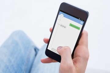 Composite image of woman using her mobile phone