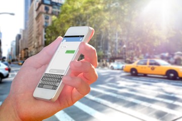 Composite image of hand holding smartphone
