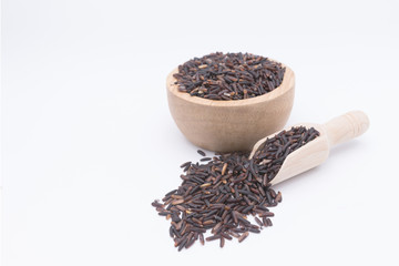 Rice berry grains in wooden spoon on white background