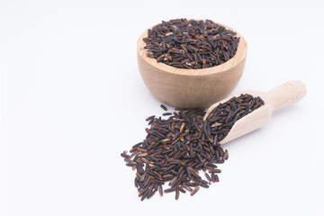 Rice berry grains in wooden spoon on white background