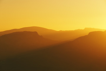 Fototapeta na wymiar mountain silhouettes at sunset