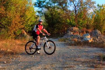 Rider on Mountain Bicycle it the forest