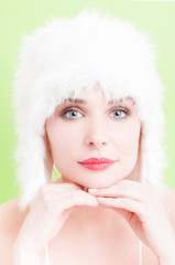 Beautiful woman with perfect skin wearing a white fur hat