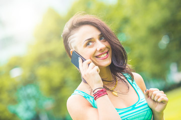 Fototapeta premium Woman talking on the phone and looking away from camera