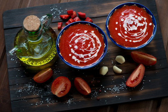 Plates with gazpacho in a rustic wooden setting, high angle view