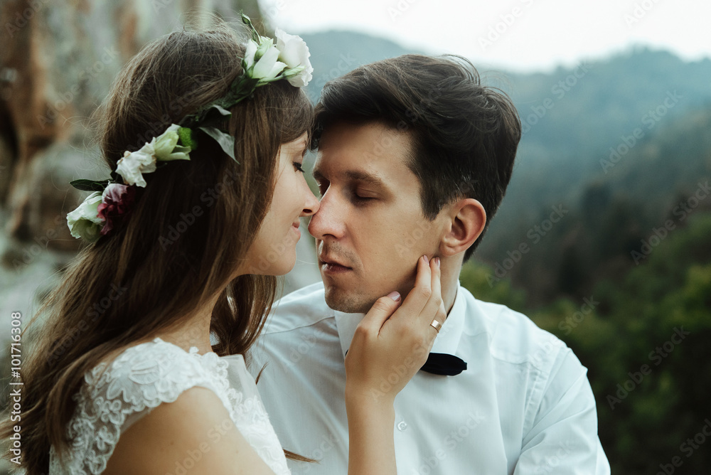 Wall mural happy luxury couple of newlyweds hugging with tender on the top