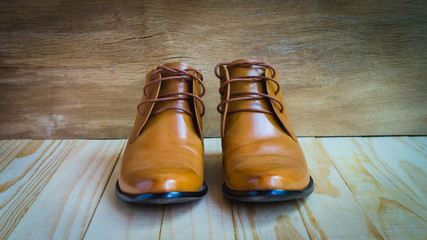 classic brown oxford shoes on wooden background