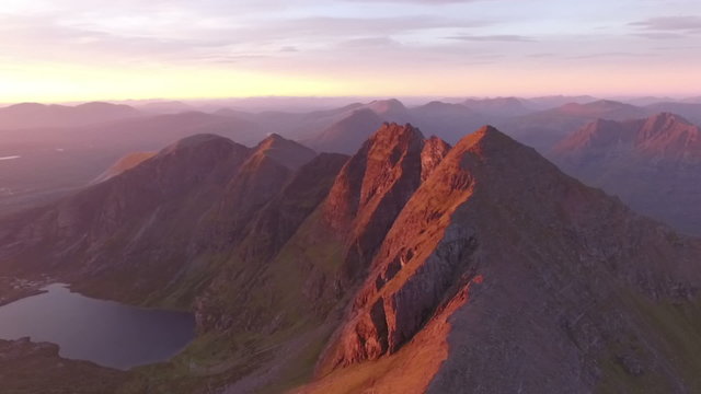 Dramatic aerial shot of An Teallach near Ullapool in the Scottish highlands during sunrise 
