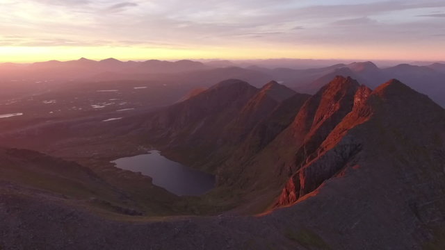 Dramatic aerial shot of An Teallach near Ullapool in the Scottish highlands during sunrise 
