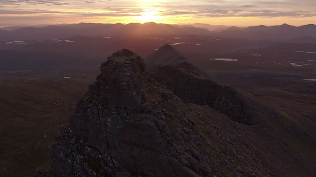 Dramatic aerial shot of An Teallach near Ullapool in the Scottish highlands during sunrise 
