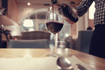 glass of wine, a restaurant serving a blurred background