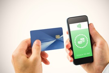 Composite image of hand holding smartphone