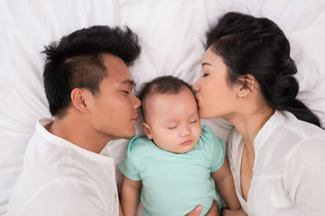 Sleeping mom, dad and baby