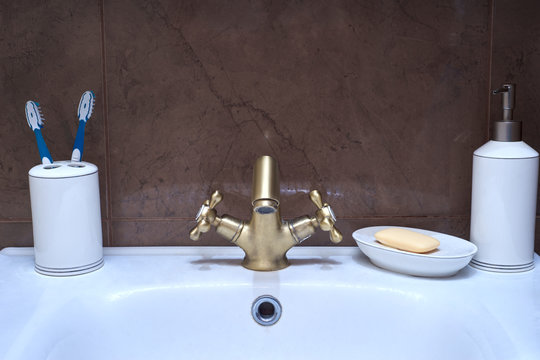 Modern water tap in the bathroom. Flowing water.