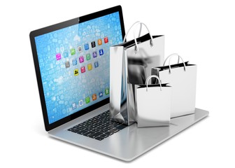 laptop and  shopping pags on white background