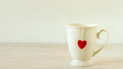 Retro tea cup for valentines day on wooden table