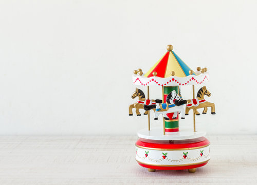 Vintage colorful carousel toy on wooden table