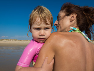 baby angry on mother shoulder