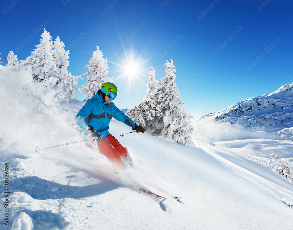 Wall mural Man skier running downhill