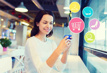 smiling woman with smartphone shopping online