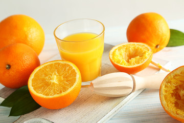 Wooden juicer and orange on a wooden table