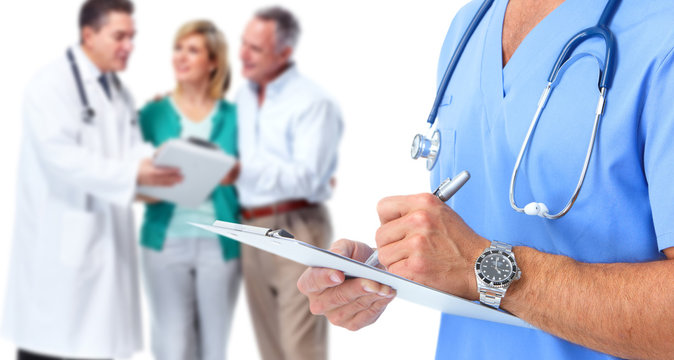 Doctor hands writing on a clipboard.