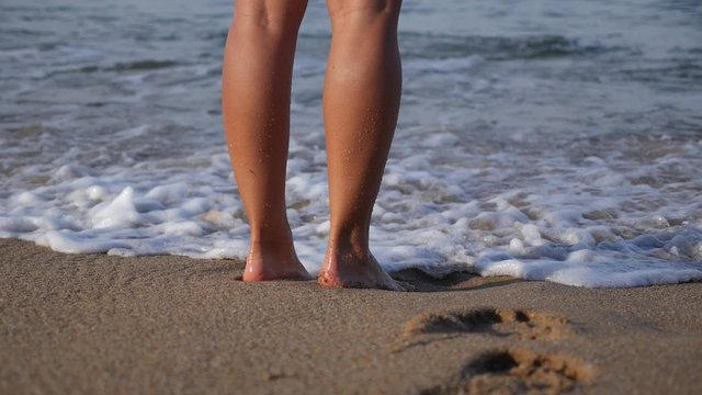 Woman Legs on Tropical Beach Enjoying Sea 