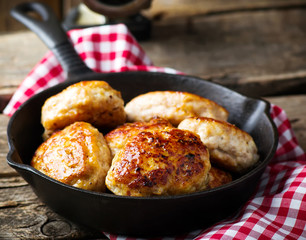 chicken cutlets on frying pan.