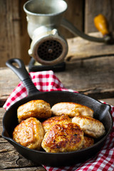 chicken cutlets on frying pan.