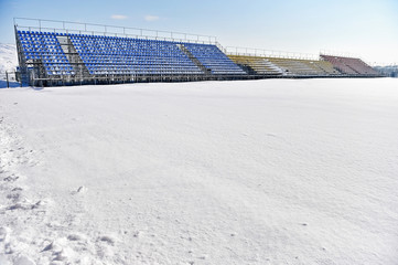 Naklejka premium Empty tribunes on a stadium after heavy snowfall