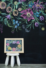 Art wall with blackboard and chalk floral painting on it as interior decoration
