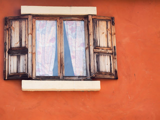 old wooden window and orange wall