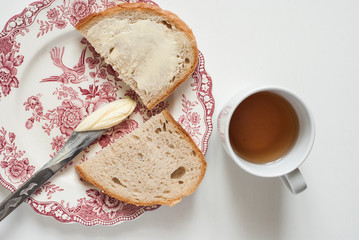 Tasty buttered bread on the vintage plate