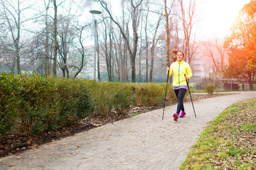 Girl make Nordic walking in the park in the city