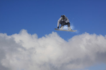 Flying snowboarder on mountains. Extreme sport.