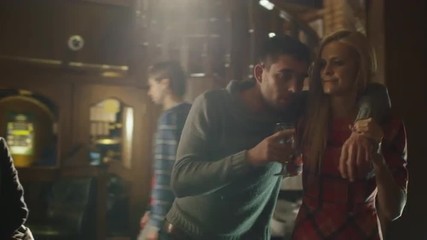 Young woman is helping her drunk friend with beer glass to go away from the bar. Shot on RED Cinema Camera.