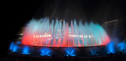 Night time in Barcelona, Spain at the magic fountain.   Colorful large fountain in Barcelona Spain provides entertainment for all ages on a warm October evening.