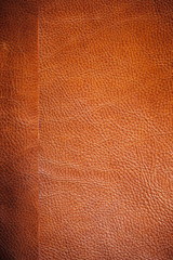 Fototapeta premium Brown leather texture closeup. Useful as background
