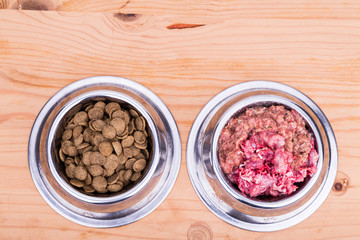 Choice of raw meat or kibbles dog food in bowl