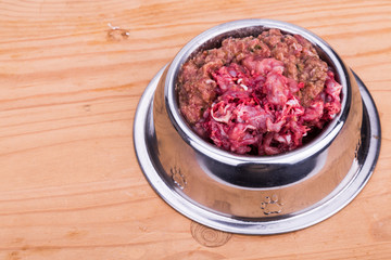 Fresh and nutritious minced raw meat and bones dog food in bowl