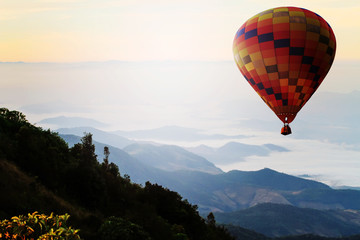Hot air balloon over mountain in sunrise. Travel concept.