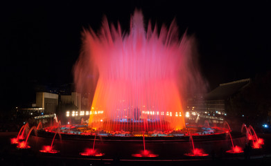 Night time in Barcelona, Spain at the magic fountain.   Colorful large fountain in Barcelona Spain provides entertainment for all ages on a warm October evening.
