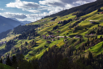 Fototapeta na wymiar Rural mountain scenery with aipine houses in the valley. Austria. Tirol region.