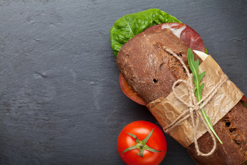 Sandwich with salad, ham, cheese and tomatoes