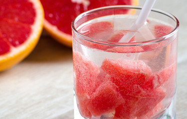 A glass of refreshing drink with grapefruit and grapefruit